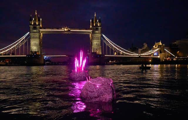 Godzilla’s bristling pink spikes, brimming with atomic power, were seen poking up from the river Thames next to Kong's giant hand, crushing an iconic London red phone box on Southbank.

The giant titan’s spine stretches an impressive 65 feet, the length of a tennis court.