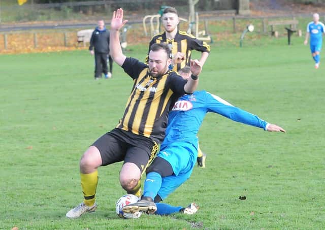 Selkirk Vics' Greg Fenton, in blue, got a second booking, and a red card, for this tackle on Jordan Steele of Stow (picture by Grant Kinghorn)