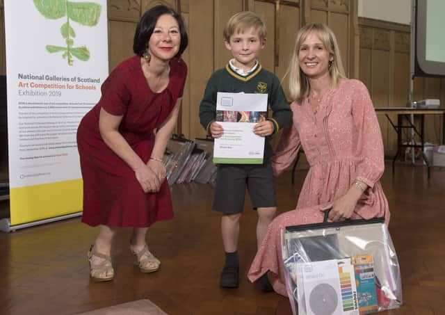 Sholto Key, accompanied by mum Viv, being presented with his prize by Suzie Huggins. Photo: Neil Hanna