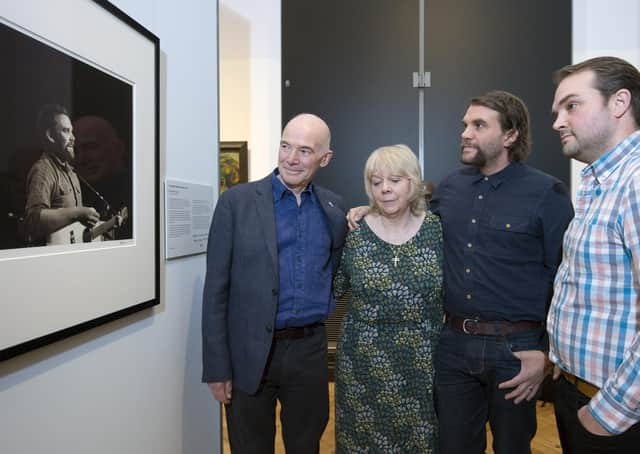 Marion and Ron Hutchison with sons Grant and Neil viewing the portrait of singer-songwriter Scott. Photo: Neil Hanna
