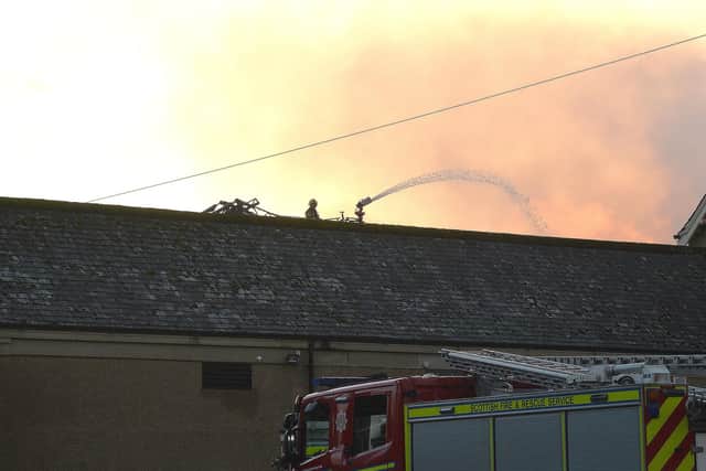Firefighters attempt to extiguish the blaze in the old gym hall.