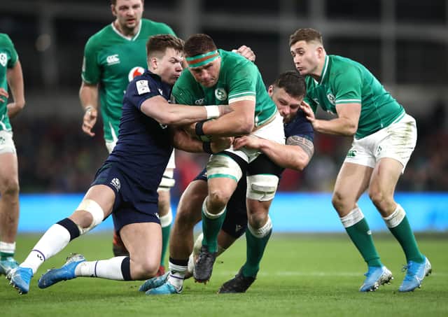 A partially-obscured Rory Sutherland, right, and Scotland team mate Huw Jones, aim to bring down Ireland's CJ Stander in last week's Guinness Six Nations tussle in Dublin. (Photo by Bryn Lennon/Getty Images)
