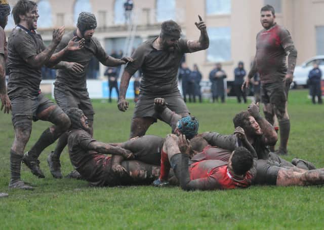 Bruce Riddell, hidden among a mass of muddy bodies, touches down for Selkirk's first try (picture by Grant Kinghorn)