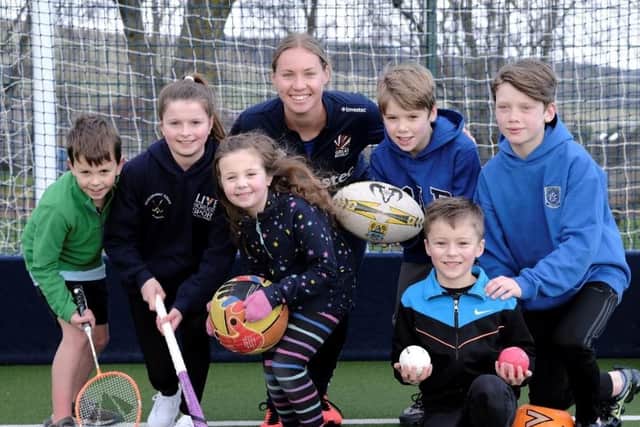 Sarah Robertson helped to launch the ‘Training for Tokyo 2020’ Games Passport along with, from left, Flynn Ferrie, Cora Dow, Belle Ferrie, James Cowens, Cameron Cowens and, front, Ollie Gillard (picture by Rob Gray)