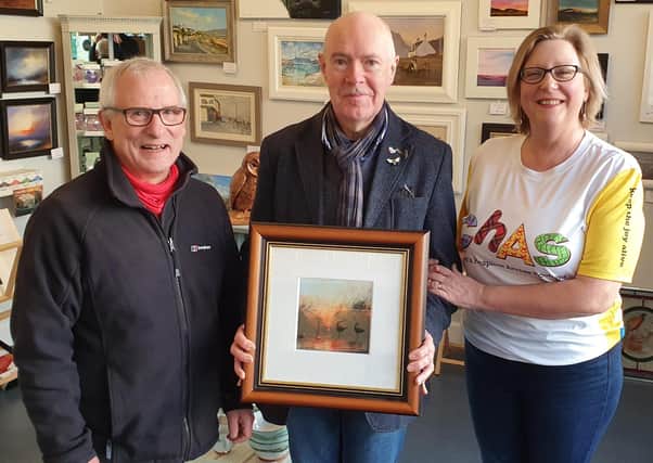 An art raffle organised by a Melrose gallery has helped a fund-raising drive for Children’s Hospices Across Scotland (CHAS) reach the £13,000 mark.
Borders artist David Hay donated one of his paintings, entitled ‘River, Late Sun’, to The Gallery Melrose which raised £400 in ticket sales.
The raffle, which was won by Willie Frew from Stow, was arranged by gallery owners Iain Louden and David Wallace in a bid to boost Iain’s wife Sally’s fund-raising efforts to help children with life-shortening illnesses and their families. Pictured from left, David Hay, David Wallace and Sally Loudon.