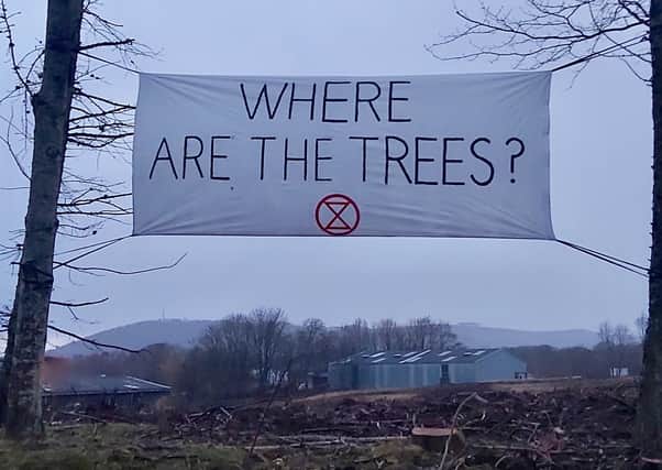 Action was taken last Sunday evening by Extinction Rebellion Scottish Borders (ERSB) to reinforce its message that mature carbon-absorbing trees must be protected in all planning decisions taken by Scottish Borders Council.  This comes after clear felling was approved for the Borders Gateway development at Tweedbank. ERSB members made banners out of recycled materials which they attached to some of the few remaining trees on the site.
