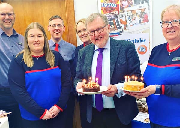 Staff at a Peebles building society branch used the occasion of their Eastgate premises’ 40th birthday to raise funds for Parkinson’s UK.
Tweeddale MP David Mundell, who was holding one of his regular surgeries in the town, dropped in to join employees and customers celebrating the anniversary at the Nationwide branch, previously part of the Dunfermline Building Society. Pictured, from left, Angus MacIntyre (financial planning manager), Laura Dawkins (member representative), Scott Menzies (branch manager), Joyce MacIntyre (member representative), David Mundell and Linda Volpe (member representative).
