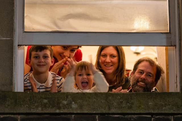 The Heneveld family at their window in Lauder cheering and clapping for the NHS.

Photo by Phil Wilkinson / Alamy Live News