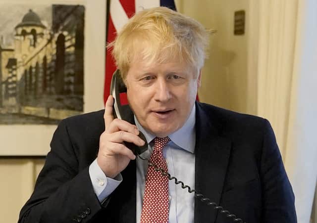 UK prime minister Boris Johnson on the telephone to Queen Elizabeth II for a weekly audience on March 25. (Photo by Andrew Parsons/WPA Pool/Getty Images)