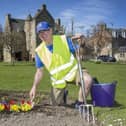 Chico (Brian Woods) from the Jedburgh Community Volunteer Enhancement Group creates a rainbow in a bed at Mary Queen of Scots house gardens in Jedburgh.