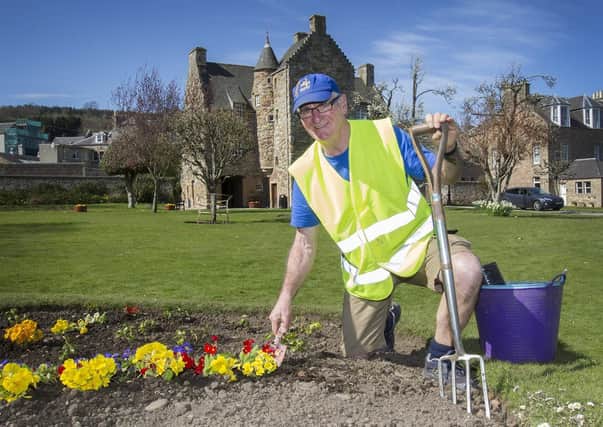 Chico (Brian Woods) from the Jedburgh Community Volunteer Enhancement Group creates a rainbow in a bed at Mary Queen of Scots house gardens in Jedburgh.