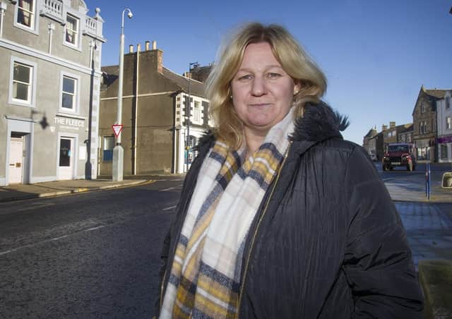 Councillor Caroline Cochrane alongside a CCTV camera in Selkirk town centre.