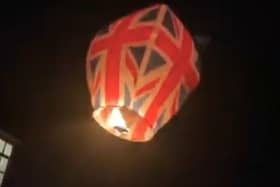 A still image of a Union Flag paper lantern being released supposedly in support of the National Health Service.