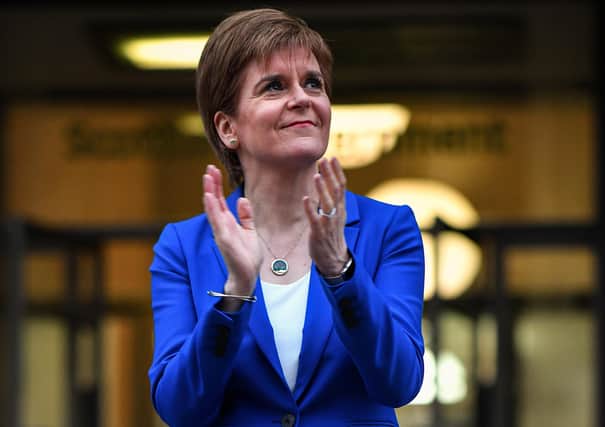 Scottish first minister Nicola Sturgeon showing her appreciation  in Edinburgh last night during the weekly tribute to NHS and key workers dealing with the current coronavirus outbreak. (Photo by Jeff J Mitchell/Getty Images)