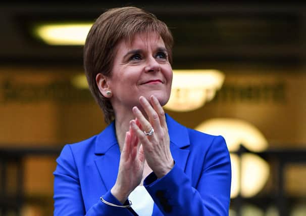 Scottish first minister Nicola Sturgeon joining in the latest nationwide round of applause for medics and other key workers in Edinburgh last night. (Photo by Jeff J Mitchell/Getty Images)