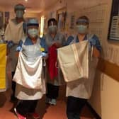 Ward 4 nurses at the Borders General Hospital with scrub bags donated to them by volunteers from Selkirk.