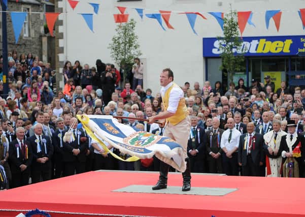 2018 standard bearer Peter Forrest casts the burgh flag during that year's common riding Friday festivites.