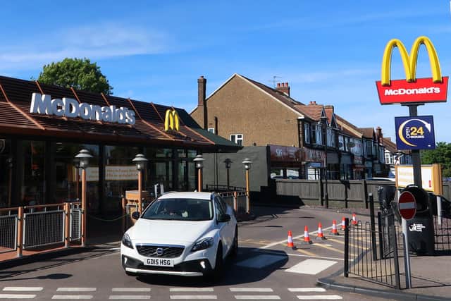 Customers leaving the reopened North Cheam McDonald's drive-through in London yesterday. (Photo by Mark Trowbridge/Getty Images)