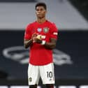 Manchester United's Marcus Rashford applauds following a one-minute silence commemorating victims of the Covid-19 pandemic prior to his side's 1-1 draw against Tottenham Hotspur last Friday. (Photo by Matt Childs/pool via Getty Images)