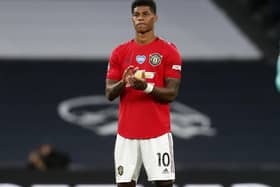 Manchester United's Marcus Rashford applauds following a one-minute silence commemorating victims of the Covid-19 pandemic prior to his side's 1-1 draw against Tottenham Hotspur last Friday. (Photo by Matt Childs/pool via Getty Images)