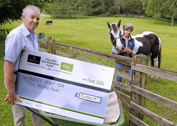 Gareth Baird, chairman of the Fallago environment fund, delivering a cheque for £5,000 to Susie Elliot, a trustee of the Borders group of the Riding for the Disabled Association.