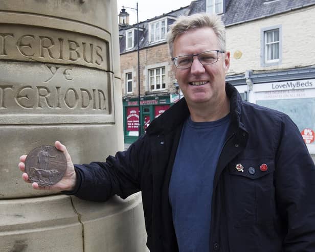 Calum Ross in Hawick with William Walker Tait's death plaque.