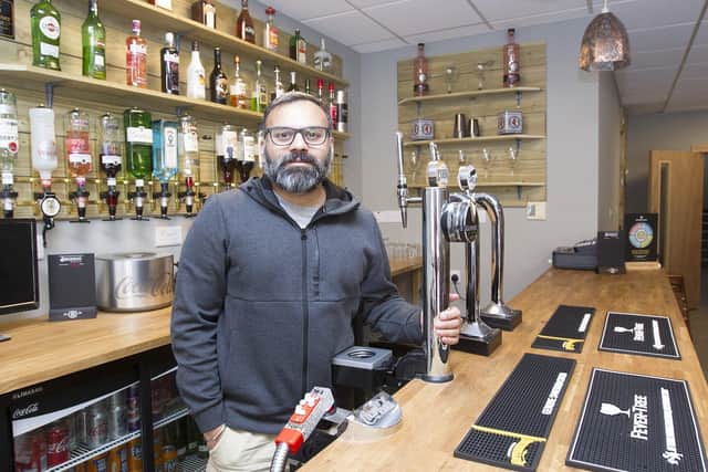 Raj Kumar, owner of the Punjabi Grill in Hawick, behind its bar.