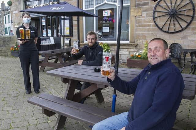 Nicky Shiels and David Easton enjoying alfresco beers at the Carters' Rest in Jedburgh as Jen Craig delivers another round.