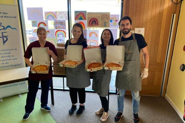 Emily Crolla, Dana Tambaloiu and Florin Nicolae deliver 100 free pizzas to NHS staff at the BGH.