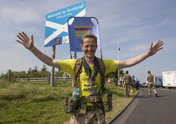 Army major Chris Brannigan arrives at Carter Bar bound for Jedburgh on the latest leg of his 700-mile barefoot fundraising walk from Cornwall to Edinburgh. Photo: Bill McBurnie
