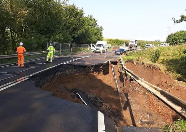 Fencing is put up where a massive section of the A68 between Pathhead and Fala Dam collapsed.