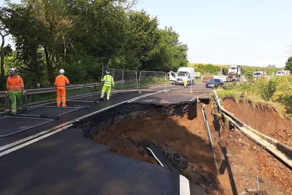 Fencing is put up where a massive section of the A68 between Pathhead and Fala Dam collapsed.