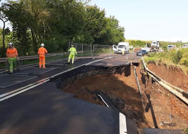 Fencing is put up where a massive section of the A68 between Pathhead and Fala Dam collapsed