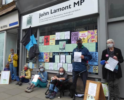 A protest by members of Extinction Rebellion outside John Lamont's constituency office in Hawick High Street.