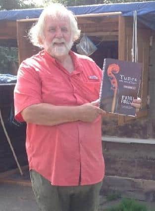 A happy Riddell Fiddles member, John McIlroy, with his copy of the new tune book, which was sponsored by Holequest.