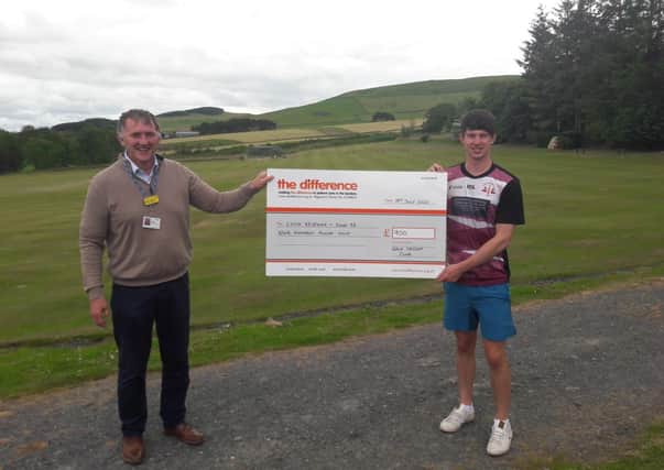 Brian Renwick, fundraising officer at The Difference, receives a £900 cheque from Ross Patterson of Gala Cricket Club.