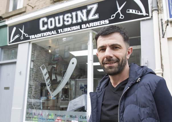 Cem Kokuc oustide his new Turkish Barber shop, CousinZ in Jedburgh's High Street