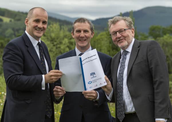 UK northern powerhouse minister Jake Berry, Scottish infrastructure secretary Michael Matheson and Borders MP David Mundell agreeing heads of terms for the Borderlands deal at Glentress in July last year.