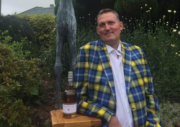 Doddie Weir with a bottle of Glenkinchie single malt whisky.