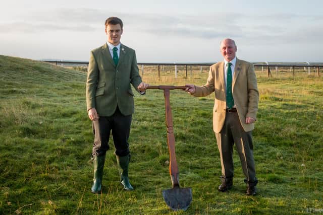 Hawick Cornet Connor Brunton handing back a ceremonial spade to common riding committee chairman John Hogg at the town's moor racecourse after cutting a sod at the Ca' Knowe. Photo: ILF Imaging