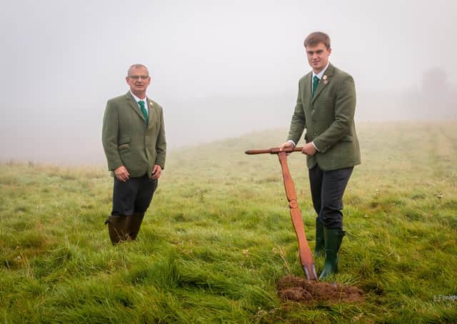 Hawick Cornet Connor Brunton, watched by acting father Joe Crawford, cutting a sod of earth at the Ca' Knowe, south of the town. Photo: ILF Imaging