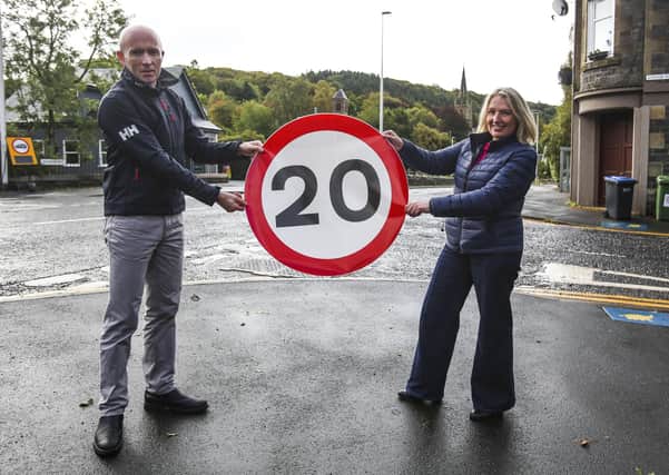 Ross Murphy, a member of Stow Community Council and Grace Murray of Stow Community Trust celebrate the introduction of the village's 20mph speed limit today.
