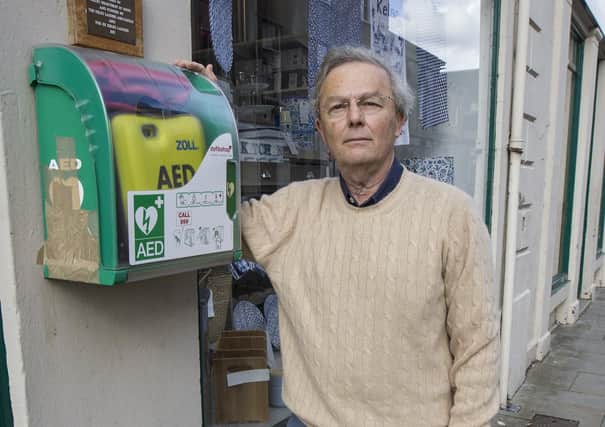 Kelso Heartbeat trustee Martin Hadshar with the damaged defibrillator cabinet in Kelso’s town square.