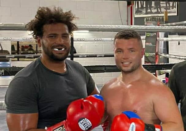 John, right, has learned a good deal from his sparring partner, Ultimate Boxer heavyweight winner Nick Webb. At 6' 5'', Webb is the same height as John's opponent next month, Russian Evgeny Tishchenko.