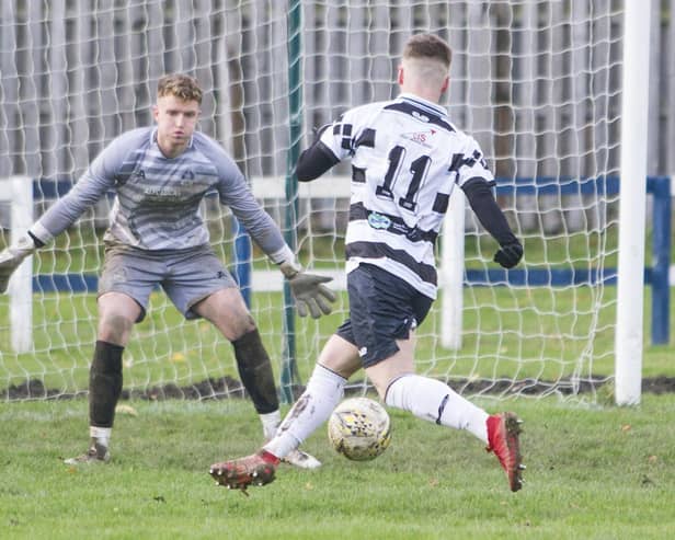 East Stirlingshire's left winger, Craig Henderson, gets ready to slot the ball past Vale of Leithen's Ben McGinley. Photo: Bill McBurnie