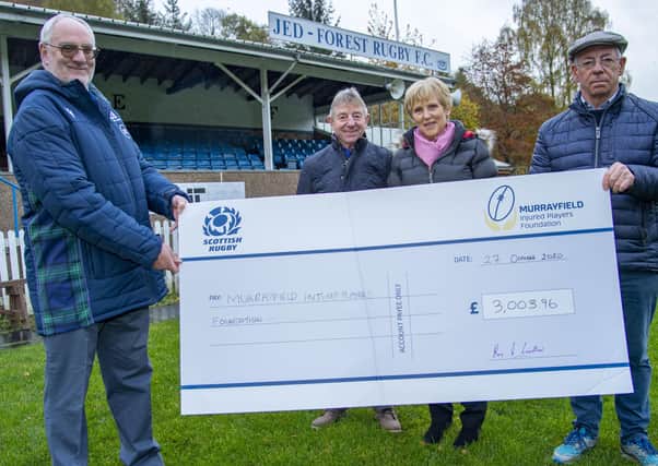 Alistair Forsyth of the Murrayfield Injured Players' Foundation is presented by Roy, Lorna and David Laidlaw with a cheque for £3,000-plus at Jed-Forest's home ground. (Photo by Bill Murray/SNS Group)