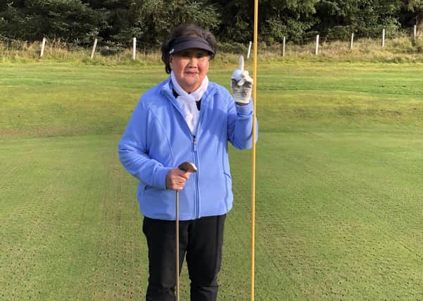 Kim Robertson celebrating getting her first-ever hole in one at Innerleithen Golf Club.