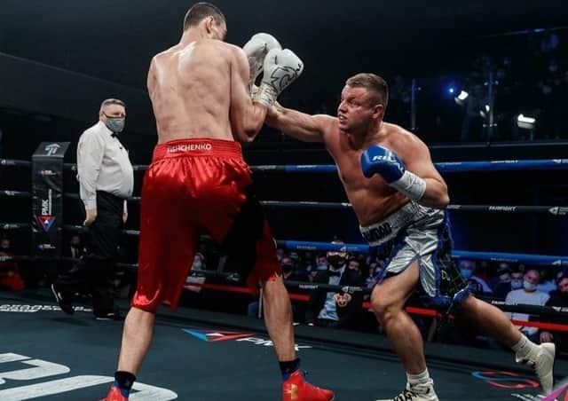 John McCallum, gives it his best shot in Russia against Evgeny Tischenko (picture by RCC Boxing Promotions)