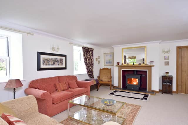 The large sitting room with bespoke fireplace, which houses a wood burning stove.