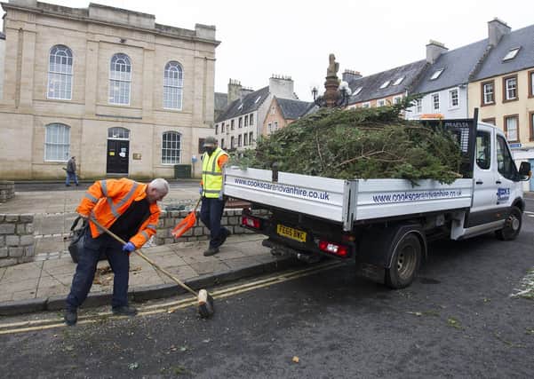 Council workers clear up after cutting down Jedburgh's Christmas tree after eyewitnesses said it was "wonky". Photo: Bill McBurnie.